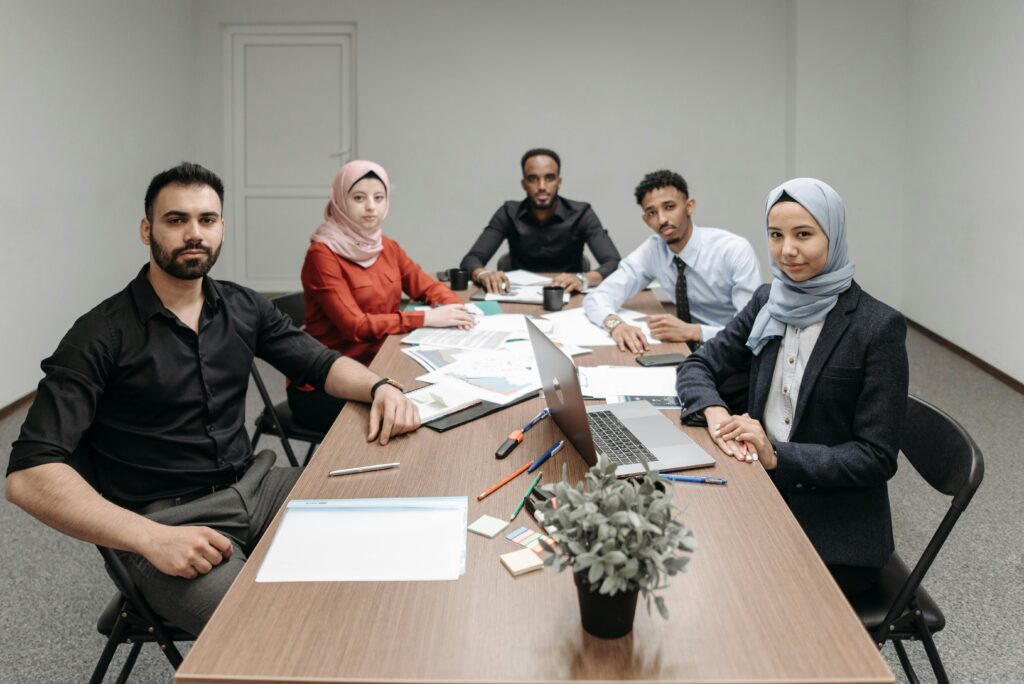 A diverse group of professionals engaging in a business meeting in a modern office setting.